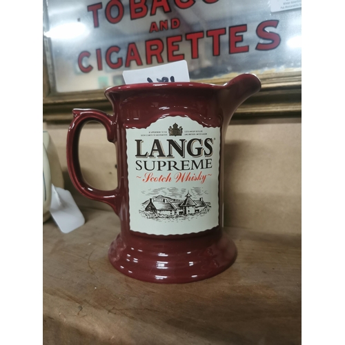 186 - Lang�s Supreme Scotch Whiskey ceramic advertising water jug. {14 cm H x 17 cm W x 10 cm D}.