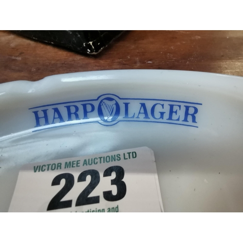 223 - Harp Lager glass advertising ashtray. {2 cm H x 15 cm W x 10 cm D}.