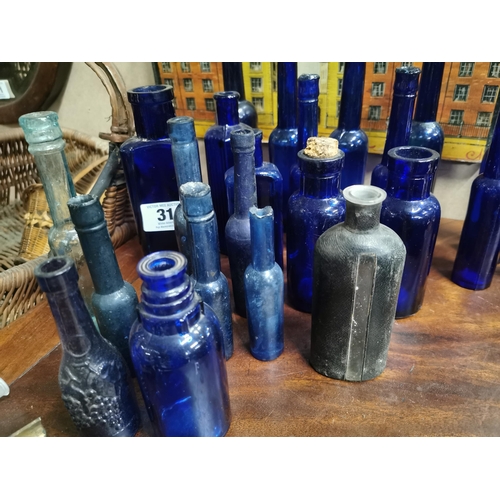 310 - Collection of 24 19th C. blue poison and castor oil bottles.