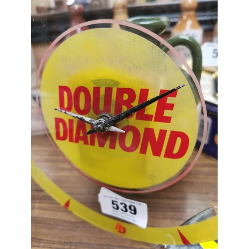 539 - Double Diamond clear perspex battery operated advertising clock. { 25 cm Dia}.