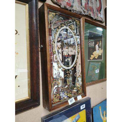 557 - Guinness clock with mahogany case and mirrored glass . {54 cm h x 27 cm W x 7 cm D}.