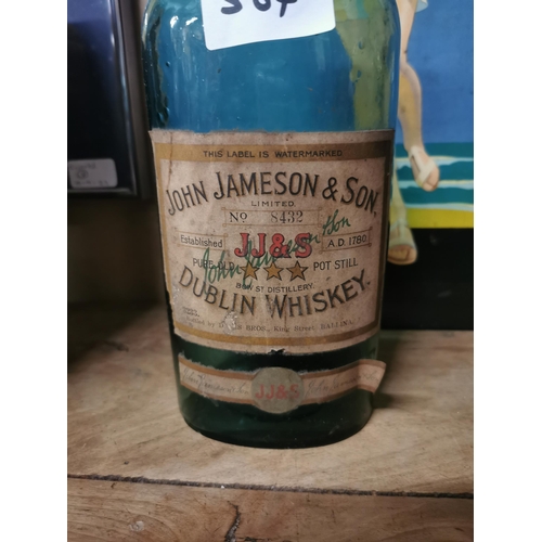 564 - Two empty John Jameson Whiskey bottles. {29 cm H x 11 cm W}