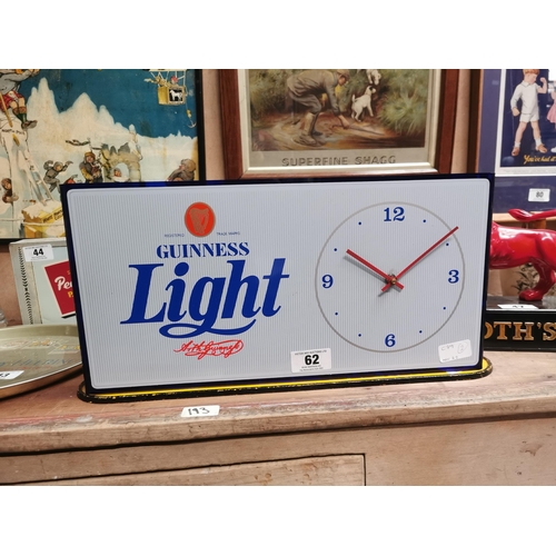 62 - Guinness Light up advertising clock. {23 cm H x 46 cm W}.