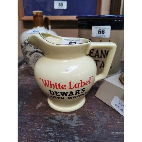 63 - Dewar�s White Label whiskey ceramic water jug. {13 cm H x 16 cm W x 12 cm D}