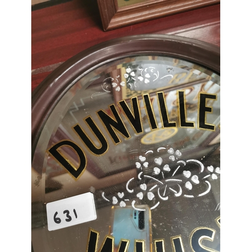 631 - Dunville's Whiskey oval advertising mirror with original brass frame. {44 cm H x 38 cm W}.