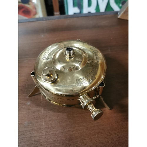 711 - Two Optimus brass and metal camping stoves. {18 cm H}.