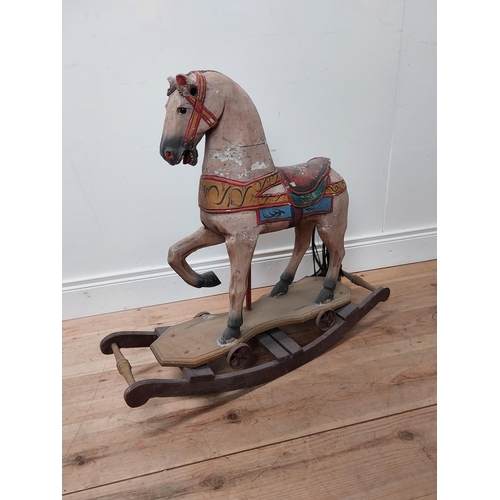 118 - Carved pine and hand painted child's rocking horse {74 cm H x 84 cm W x 25 cm D}.