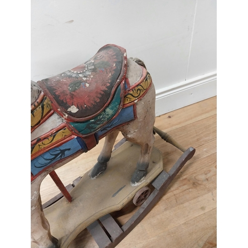 118 - Carved pine and hand painted child's rocking horse {74 cm H x 84 cm W x 25 cm D}.