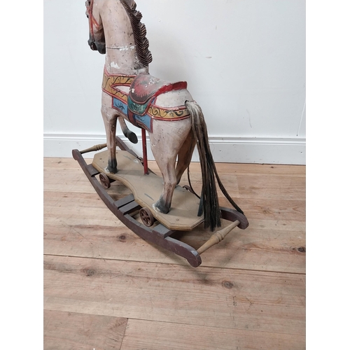 118 - Carved pine and hand painted child's rocking horse {74 cm H x 84 cm W x 25 cm D}.