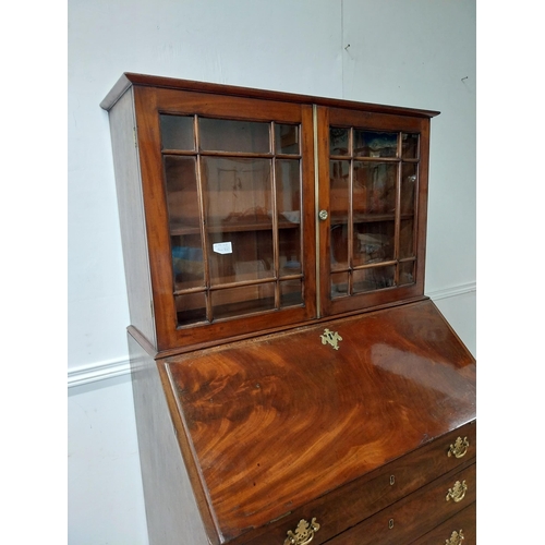 23 - Georgian mahogany bureau bookcase with two glazed panel doors above four graduated drawers and fitte... 