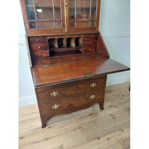 23 - Georgian mahogany bureau bookcase with two glazed panel doors above four graduated drawers and fitte... 