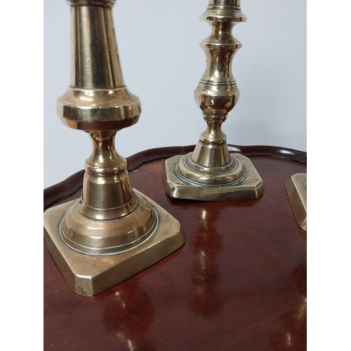 25 - Three 19th C. brass candlesticks {21 cm & 19 cm H}.