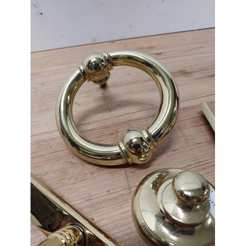 27 - Collection of brass door furniture including knocker and two handles {Knocker 14 cm H x 14 cm W and ... 