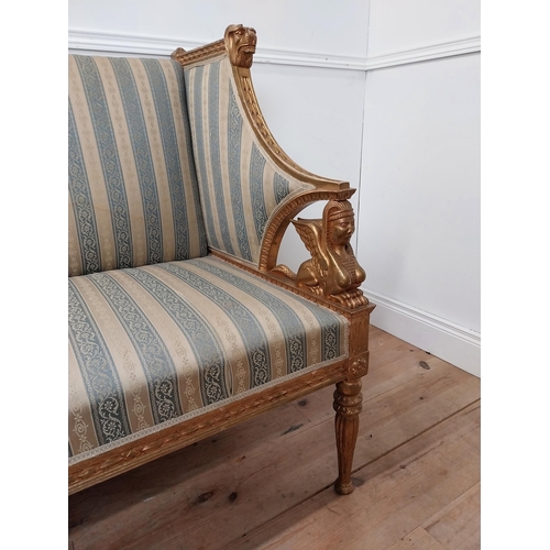 51 - Good quality giltwood and upholstered sofa in the Regency style decorated with lions mask and sphinx... 