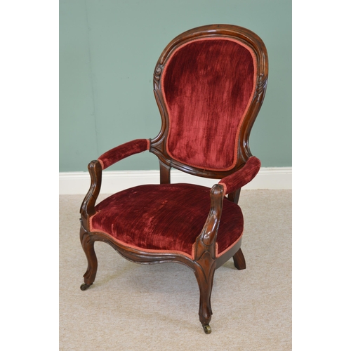 59 - Victorian mahogany and red velvet upholstered armchair raised on cabriole legs {110cm H x 62cm W}.
