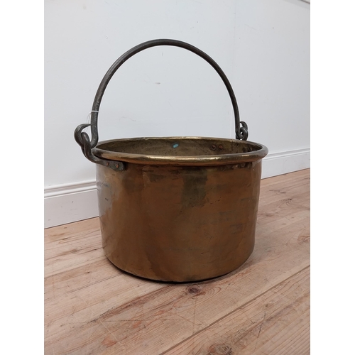 72 - Early 20th C. brass log bucket with wrought iron handle {54 cm H x 53 cm Dia.}.