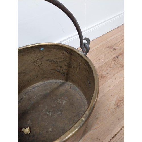 72 - Early 20th C. brass log bucket with wrought iron handle {54 cm H x 53 cm Dia.}.