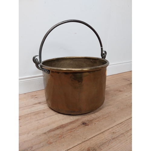 72 - Early 20th C. brass log bucket with wrought iron handle {54 cm H x 53 cm Dia.}.