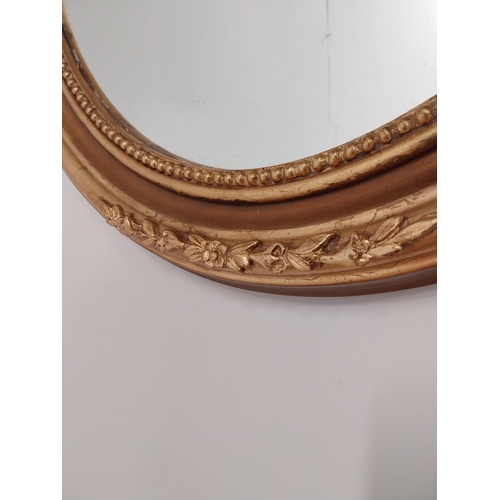 79 - Good quality gilt circular wall mirror with bevelled glass {70 cm H x 60 cm W}.