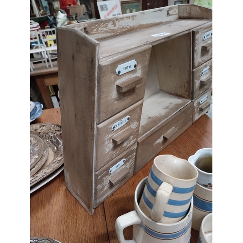 1059 - Early 20th C. painted pine herb drawers in the shape of a triangle  {43 cm H x 67 cm W x 16 cm D}.