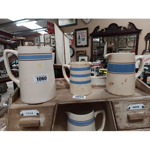 1060 - Collection of nine blue and white Carrigaline Pottery ceramic jugs and mugs made in Ireland.