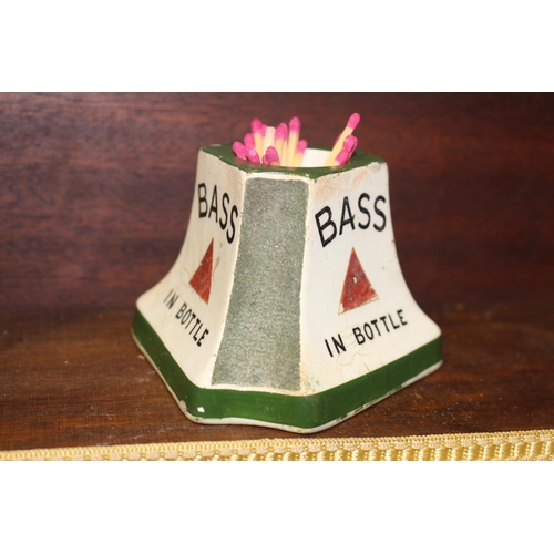 124 - Bass in bottle ceramic match strike and holder. { 7 cm H x 10 cm W x 10 cm D}.