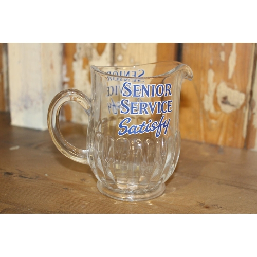 160 - Senior Service Satisfy glass advertising water jug. { 12 cm H x 14 cm W x 8 cm D}.