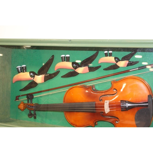 162 - Three Guinness Toucans and a Violin glazed showcase {37 cm H x 75 cm W x 16 cm D}.