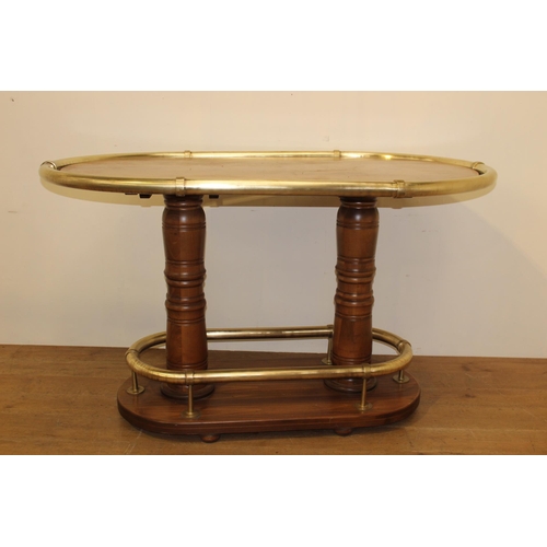 214 - Oak oval drinks stand with brass hand rail and brass foot rest. { 106 cm H x 178 cm W x 108 cm D}.