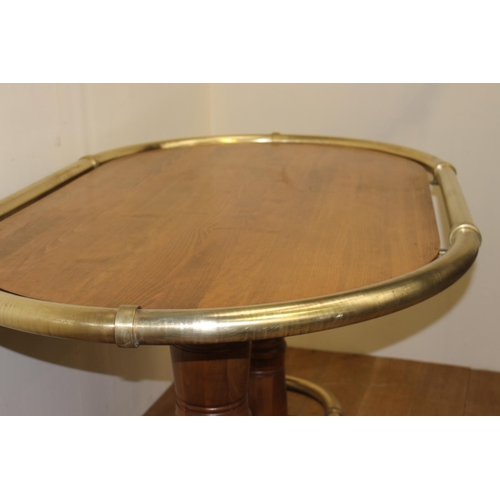 214 - Oak oval drinks stand with brass hand rail and brass foot rest. { 106 cm H x 178 cm W x 108 cm D}.