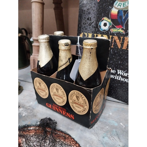 247 - Five bottles of Guinness extra stout St. James Gate Dublin, in cardboard advertising carrier {22cm H... 