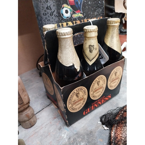 247 - Five bottles of Guinness extra stout St. James Gate Dublin, in cardboard advertising carrier {22cm H... 