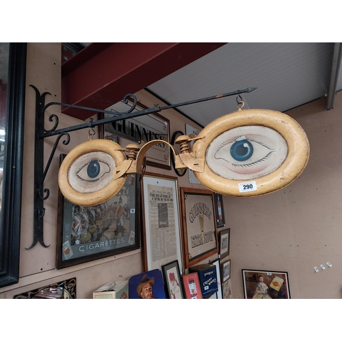 290 - Unusual Painted metal Optician's sign on painted metal bracket. {70 cm H x 100 cm W}.