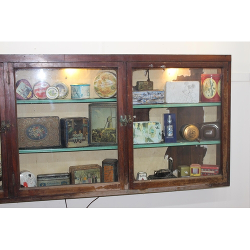 295 - 19th C. mahogany display cabinet with three glazed doors. { 80 cm H x 196 cm W x 15 cm D}.