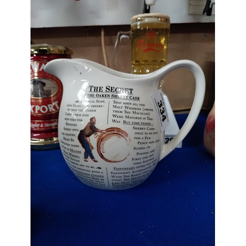 334 - MacCallan Whiskey ceramic advertising water jug. {16 cm H x 18 cm W x 10 cm D}.