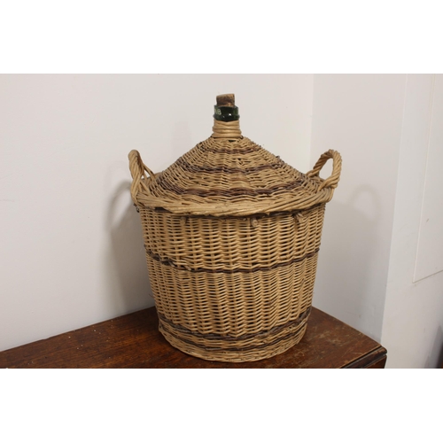 414 - Large wine bottle in wicker case {55 cm H x 43 cm Dia.}.