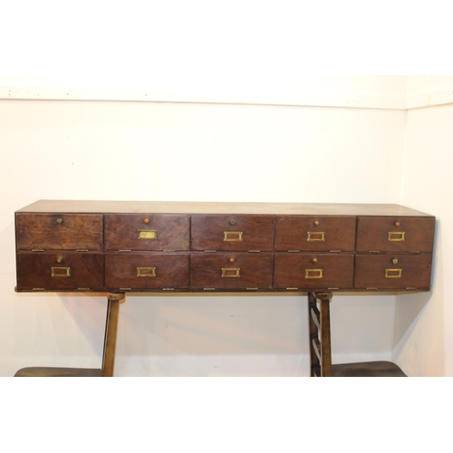 43 - Mahogany bank of ten drawers with brass fittings. {28 cm H x 150 cm W x 39 cm D}.