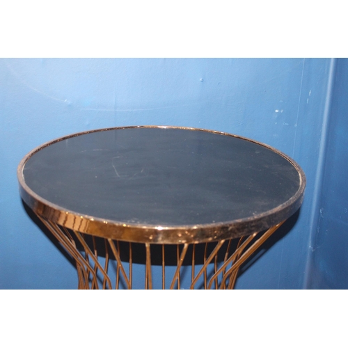 102 - Brass side table with inset black glass top {H 74cm x Dia 60cm}.