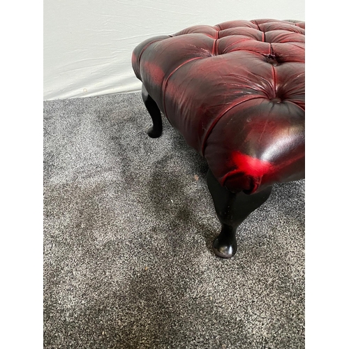 105 - Deep buttoned ox blood red leather footstool raised on cabriole legs. {32 cm H x 59 cm W x 59 cm D}.