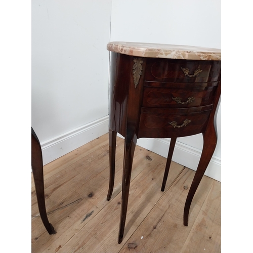 128 - Pair of mahogany inlaid oval bedside cabinets with marble tops raised on serpentine legs {72 cm H x ... 