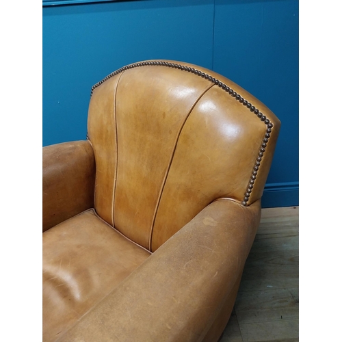 18 - Exceptional quality 1940s tanned leather club chair with brass studs raised on square tapered legs {... 
