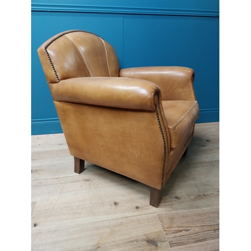 18 - Exceptional quality 1940s tanned leather club chair with brass studs raised on square tapered legs {... 