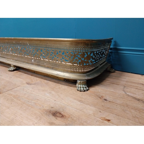 198 - Irish Georgian pierced brass fender raised on loin's paw feet. {25 cm H x 146 cm W x 28 cm D}.