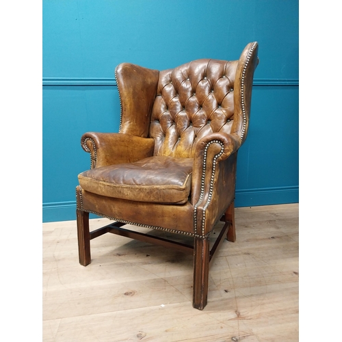 20 - Early 20th hand dyed cigar leather deep buttoned wingback armchair {106 cm H x 80 cm W x 79 cm D}.