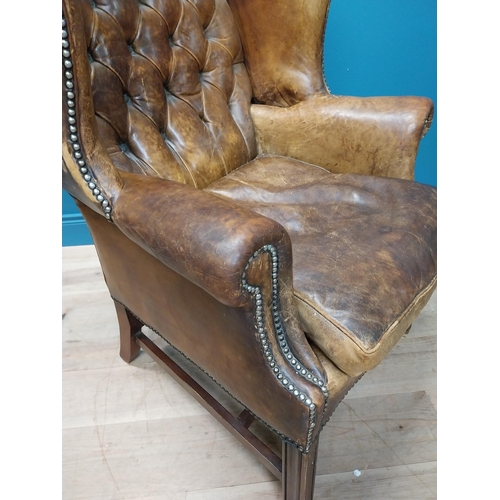 20 - Early 20th hand dyed cigar leather deep buttoned wingback armchair {106 cm H x 80 cm W x 79 cm D}.