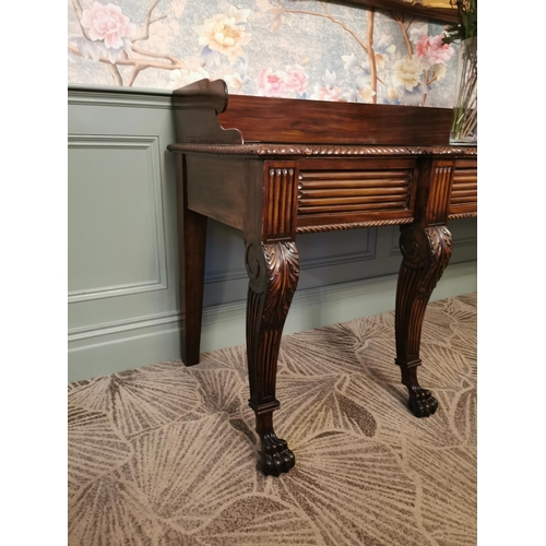 241 - Irish Regency mahogany consul table with gallery back and carved central panel raised on cabriole le... 