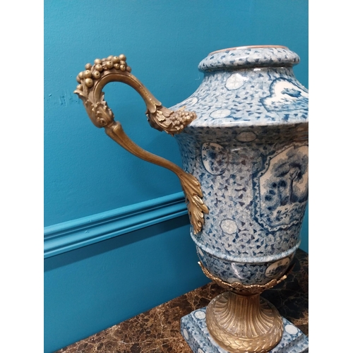 256 - French blue and white ceramic urn with ormolu mounts {47 cm H x 41 cm W x 22 cm D}.