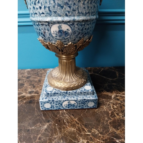 256 - French blue and white ceramic urn with ormolu mounts {47 cm H x 41 cm W x 22 cm D}.