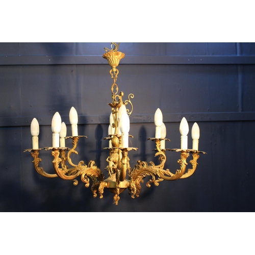 322 - Bronze eight branch chandelier decorated with cherubs and scrolls {H 73cm x Dia 85cm}.