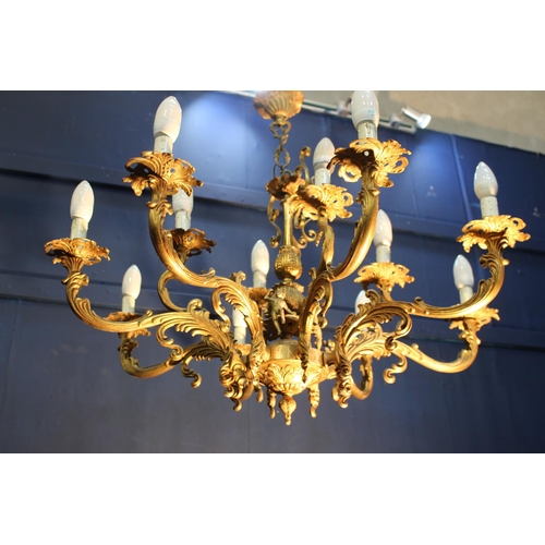 322 - Bronze eight branch chandelier decorated with cherubs and scrolls {H 73cm x Dia 85cm}.